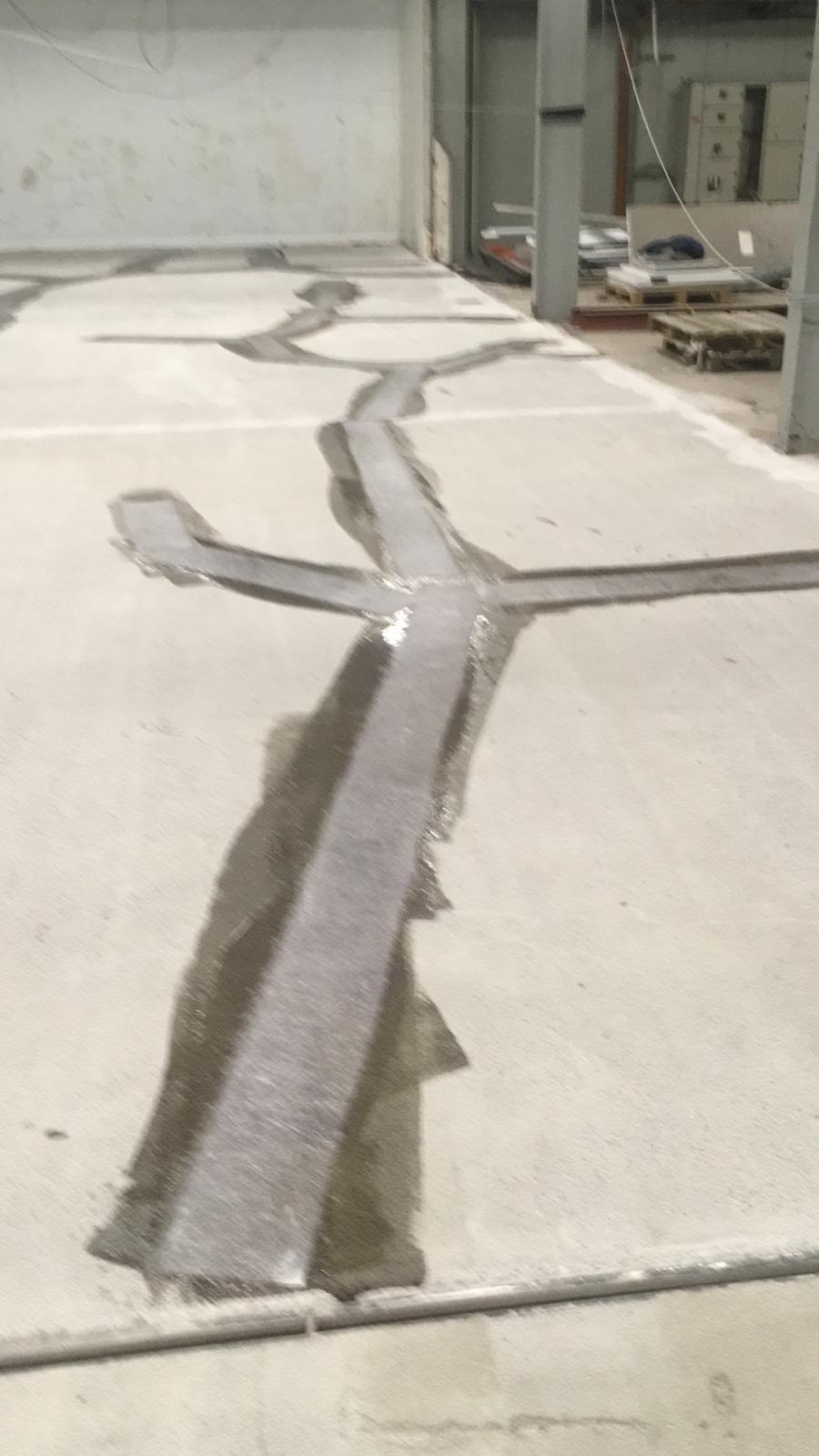 Concrete floor cracks cut out and filled ahead of coating