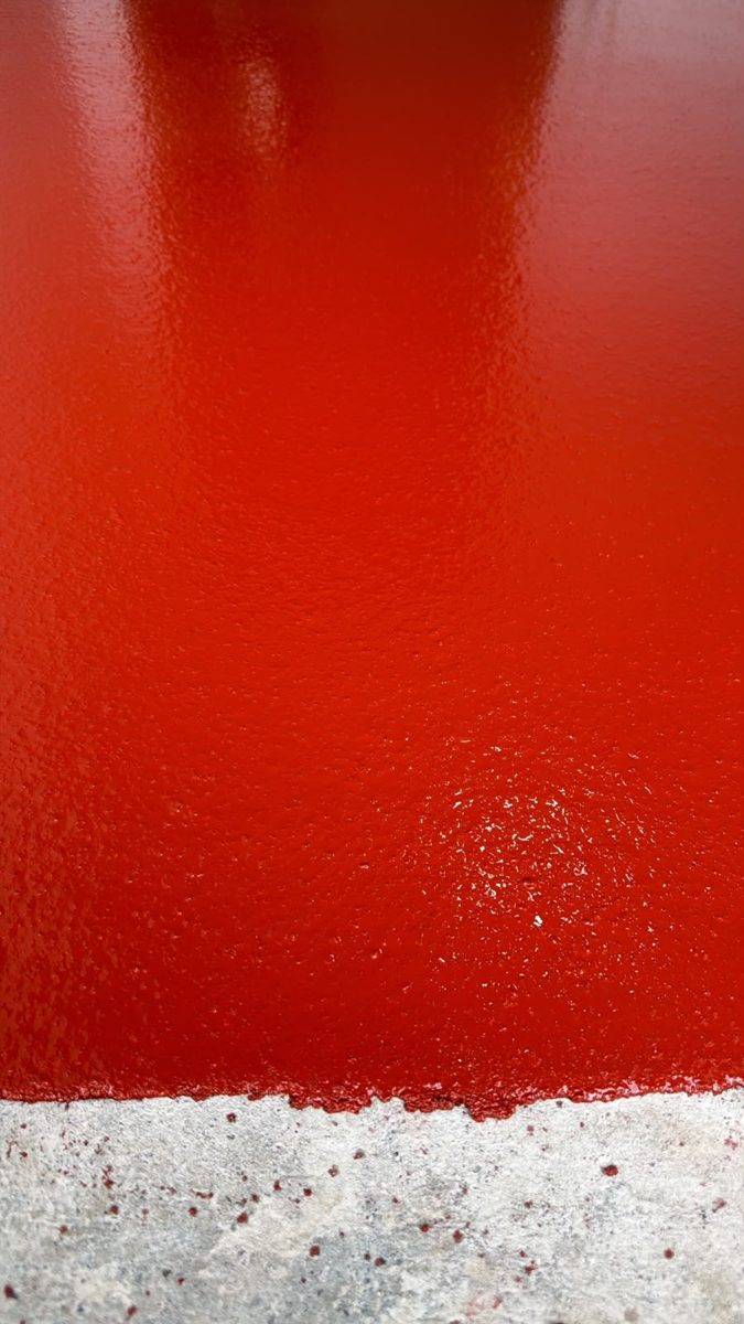Red anti-slip coat over prepared concrete